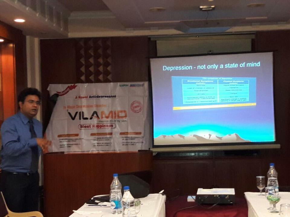 Dr. Manish Sarkar presenting on depression at a medical meeting